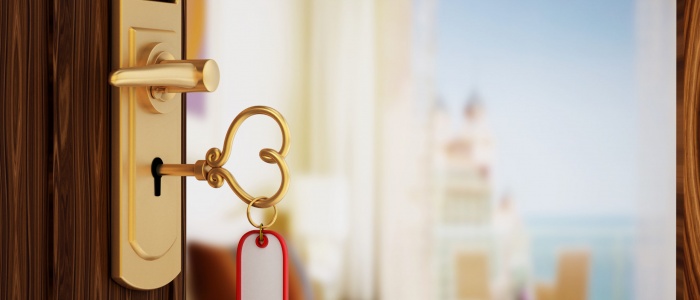 Heart shaped hotel room key on the door